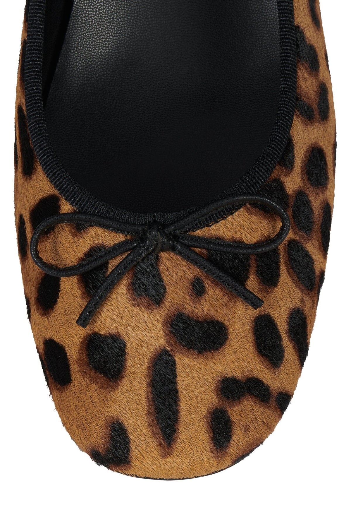 Leopard print flat shoe with a rounded toe black trim decorative black bow and soft black lining
